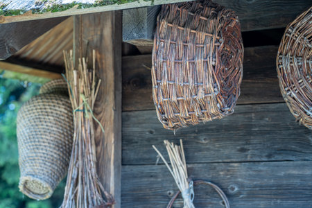 Wicker baskets on the wall of a wooden house in the villageの写真素材