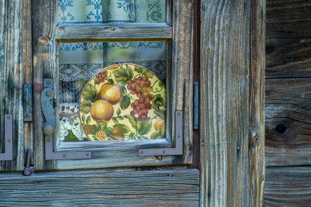 Old wooden window with a picture of fruit on the background of an old wallの写真素材