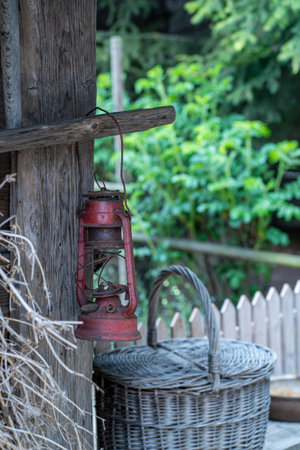 Old red lamp on a wooden wall in the garden, stock photoの写真素材