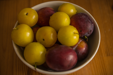 Fresh plums in bowl.の写真素材