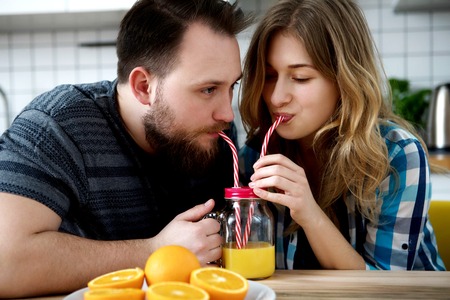 Couple drinking orange juiceの写真素材
