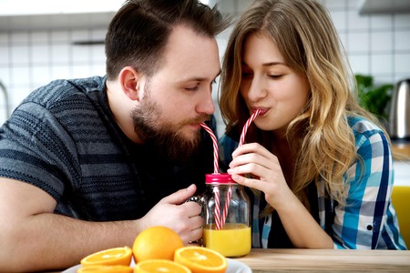 Couple drinking orange juiceの写真素材