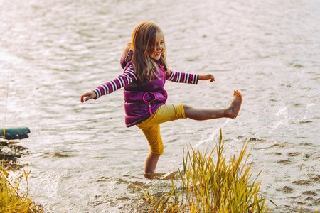 Girl playing in lakeの写真素材