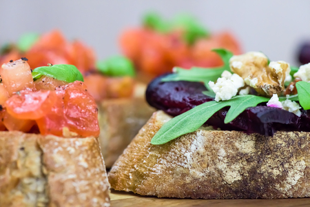 Healthy sandwiches - bread with roasted beetroot and bruschetta on light background - close up, macro shotの写真素材