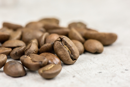 Roasted coffee beans - seeds - on light background - macroの写真素材