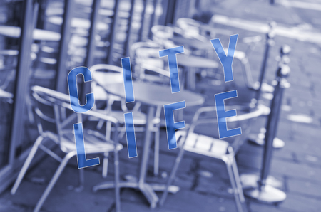 Words city life written on blurred out bar chairs and tables.の写真素材