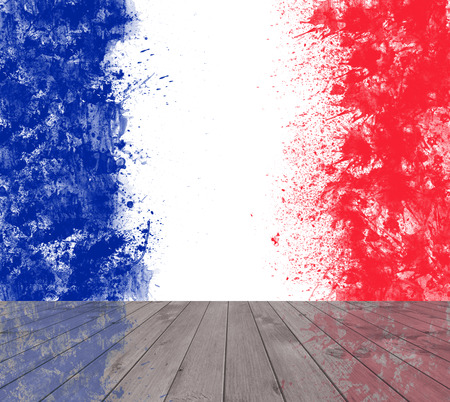 Empty wooden deck table with French flag created from splash colours blue white red.  Ready for product display montage.の写真素材