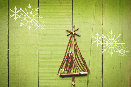 Christmas tree made from dry sticks on wooden, bright  background.の写真素材