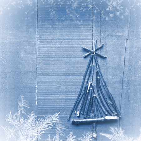 Christmas tree made from dry sticks on wooden, blue background.の写真素材