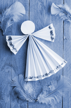 Christmas angel on blue,wooden background.の写真素材