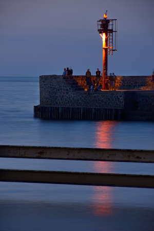 Lighthouse at the entrance to the port in Ustka, Poland, Baltic sea.の写真素材