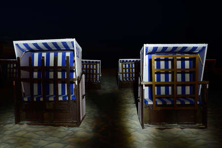 Wickler armchairs on the beach, light painting, Ustka, Poland, Baltic sea.の写真素材