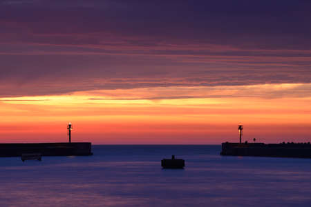 Entrance to the port in Ustka after sunset, Poland, Baltic sea.の写真素材