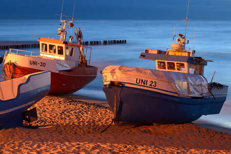 Fishing boats on the beach at night, UnieÅcie, Poland, Baltic seaの写真素材
