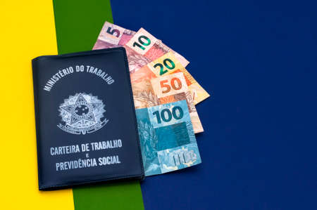 Brazilian money in wallet. Finance and salary concept. Economy of Brazil. Orange background.の写真素材
