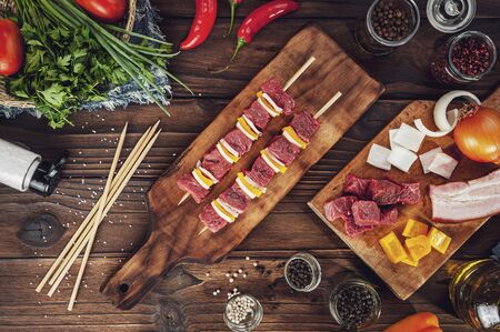 Raw meat stick with ingredients in top view - Brazilian espetinho de carneの写真素材