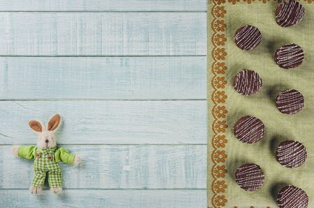 Top view of brazilian home made honey cookies chocolate covered on wooden background with stuffed...