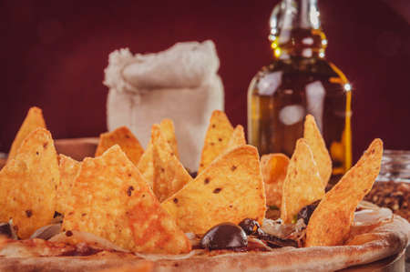 Pizza with mozzarella, onion, pepperoni, black olive, green peppers, nachos and oregano (Mexican pizza) - Closeup.の写真素材