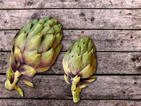 Artichokes on wooden backgroundの写真素材