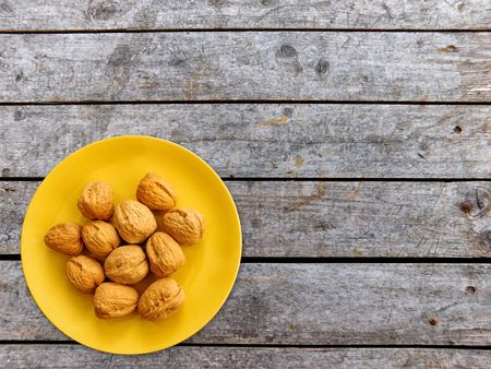 Nuts with shell on wooden backgroundの写真素材