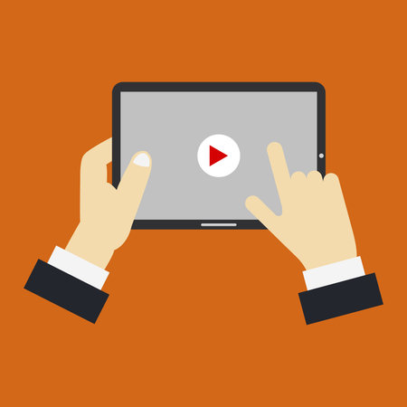 Hands holding tablet with play button. Flat design. Vector illustrationのイラスト素材