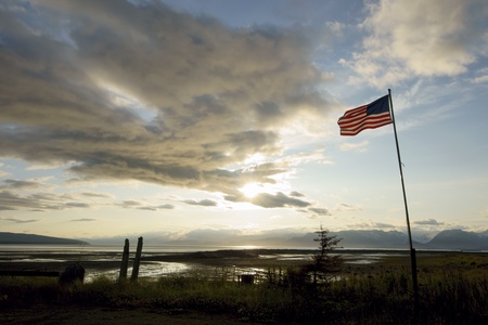 Landscape with USA flag during sunrise in Homer, Alaskaの写真素材