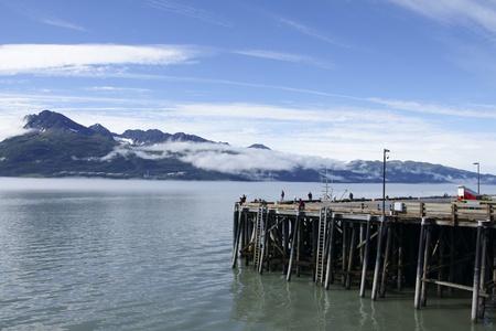 Pier in Valdez Harbor  with mountain landscapeの写真素材
