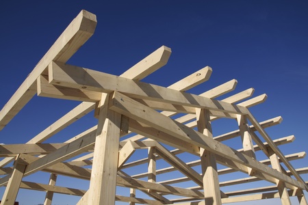 Wooden roof during the early stages of construction in a sunny day