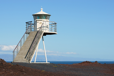 Lighthouse on lava bed in Heimaey island, Icelandの写真素材