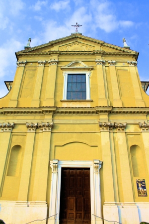 facade of yellow church in Italyの写真素材