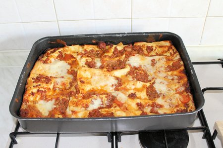 Baked lasagna in metal container from the ovenの写真素材