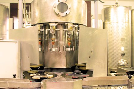 A winery capping and labeling bottle machine