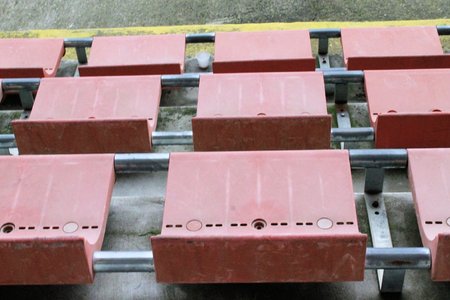 red seats for spectators in a soccer stadium