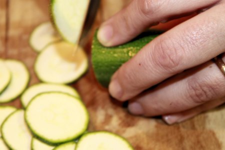 green zucchini sliced  on wooden cutting boardの写真素材