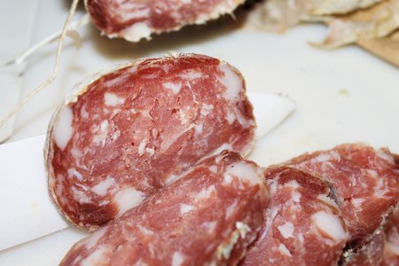 Slice of salami sausages on a boardの写真素材