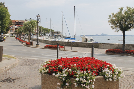 Walkway with colorful flowers on Garda lake in Italy.のeditorial素材