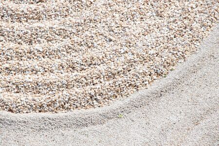 Zen garden pattern on sand and stone. Top view. Meditation and harmony.の写真素材