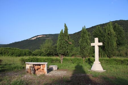 Withe marble cross against blue cloudy sky in Italyの写真素材