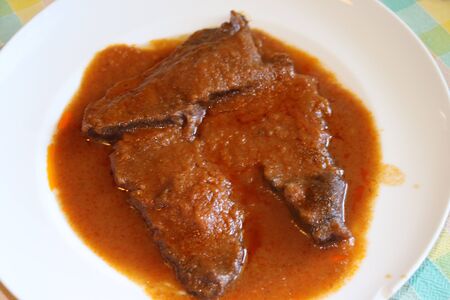 braised meat slices in the dish with sauceの写真素材