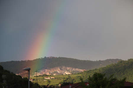 rainbow and heavy rain over the mountain valleyの写真素材