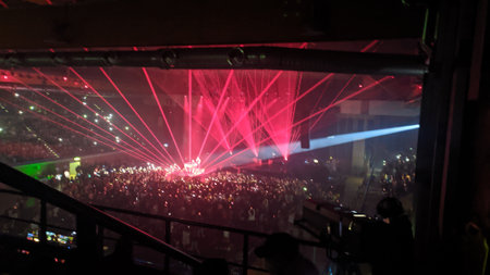 Crowd of people at a concert in the night club. Colorful laser showの写真素材