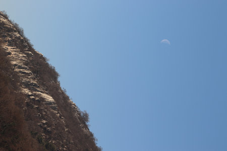 mountain and the moon in the blue sky, closeup of photoの写真素材