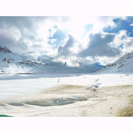 Kitesurfing in the mountains. Beautiful winter landscape. The concept of extreme sports.