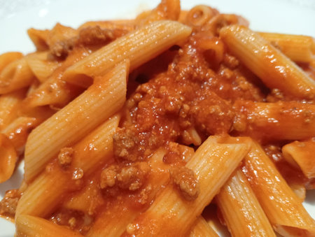 Italian short pasta penne rigata with ragu sauce or Bolognese sauceの写真素材