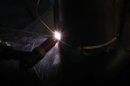 Industrial welding metal work in a factory. Sparks from welding.