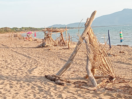 Straw umbrellas on a sandy beach in Sardinia, Italyの写真素材