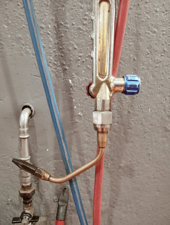 Plumbing pipes on the ceiling of a building in a construction siteの写真素材