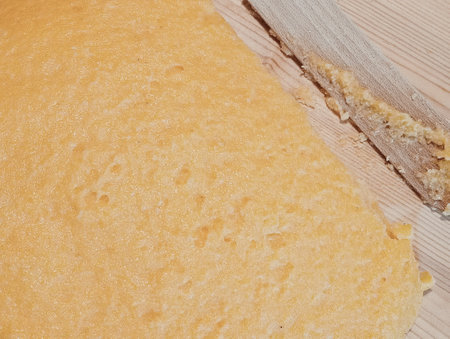 Close up of a freshly baked loaf of bread on a wooden board