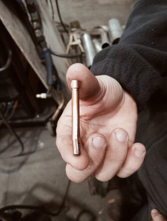 Close-up of a mechanic's hand holding a screwdriver.の写真素材