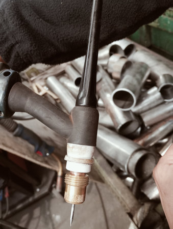 welding a pipe on a machine in a workshop, close-up